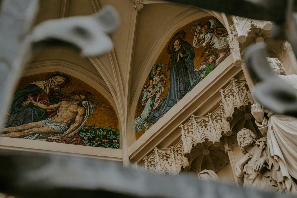 Intricate religious mosaics and statues inside a historic cathedral.